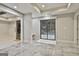 An open basement living area with gray tile flooring and natural light at 202 Firefly Ct, Peachtree City, GA 30269