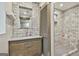 Modern bathroom with a brick wall, a floating shelf, and a glass-enclosed shower at 202 Firefly Ct, Peachtree City, GA 30269