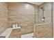 Tiled shower with a built-in bench and neutral color palette at 202 Firefly Ct, Peachtree City, GA 30269