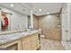 Beautiful bathroom with an oversized vanity, wood-look tile and large, glass-enclosed shower at 202 Firefly Ct, Peachtree City, GA 30269