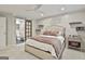 Comfortable bedroom with walk-in bathroom, a large bed with decorative shelves, and unique wall decor at 202 Firefly Ct, Peachtree City, GA 30269
