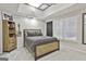 Bedroom with ceiling fan, tray ceilings and a bed with wood accents in an open and airy setting at 202 Firefly Ct, Peachtree City, GA 30269
