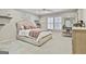 Cozy bedroom featuring a large bed, decorative shelves, closet with a mirror, and an area for a dressing table at 202 Firefly Ct, Peachtree City, GA 30269