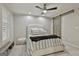 Bedroom featuring a ceiling fan, neutral decor and a comfortable bed with plush bedding and a barn door at 202 Firefly Ct, Peachtree City, GA 30269
