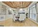 Dining room featuring custom wood plank ceiling, modern light fixture, and wainscoting at 202 Firefly Ct, Peachtree City, GA 30269