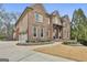 Impressive brick facade with a well-designed driveway and vibrant flower beds at 202 Firefly Ct, Peachtree City, GA 30269