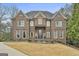 Magnificent brick home with a manicured lawn and elegant architectural details at 202 Firefly Ct, Peachtree City, GA 30269