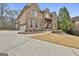 Handsome brick home featuring professional landscaping and a three-car garage at 202 Firefly Ct, Peachtree City, GA 30269