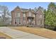 Stately brick residence with a well-maintained lawn and classic design elements at 202 Firefly Ct, Peachtree City, GA 30269
