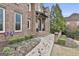 Charming brick pathway leading to the front door, surrounded by lush greenery at 202 Firefly Ct, Peachtree City, GA 30269