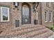 Elegant brick steps lead to a stylish front door with decorative accents at 202 Firefly Ct, Peachtree City, GA 30269