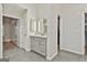 Bathroom hallway with gray tile flooring, vanity with marble countertop, and access to closets and rooms at 202 Firefly Ct, Peachtree City, GA 30269