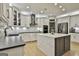 Stylish kitchen with an island, stainless steel appliances, pendant lights, and modern finishes at 202 Firefly Ct, Peachtree City, GA 30269