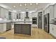 Bright kitchen featuring an island, stainless steel appliances, and white cabinets providing a modern aesthetic at 202 Firefly Ct, Peachtree City, GA 30269