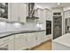 Modern kitchen with stainless steel range hood, built-in microwave, white cabinets and hardwood flooring at 202 Firefly Ct, Peachtree City, GA 30269
