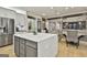 Open concept kitchen, dining, and living space with stainless steel appliances and hardwood flooring at 202 Firefly Ct, Peachtree City, GA 30269
