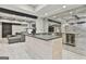Basement kitchenette with a wooden island, mirrored backsplash, and bar seating at 202 Firefly Ct, Peachtree City, GA 30269