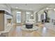 Elegant living room featuring a stone fireplace, hardwood floors, and stylish furniture at 202 Firefly Ct, Peachtree City, GA 30269
