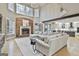 Bright living room with fireplace, hardwood floors, and view to kitchen at 202 Firefly Ct, Peachtree City, GA 30269