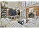 Spacious living room with built-in media center, fireplace, and large windows at 202 Firefly Ct, Peachtree City, GA 30269