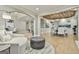 Open-concept space with living area and dining area with wood-planked ceiling, connected by archways at 202 Firefly Ct, Peachtree City, GA 30269