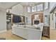 Inviting living room boasting a large TV, custom built-ins, and lots of natural light at 202 Firefly Ct, Peachtree City, GA 30269