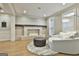 Bright living room with stone fireplace, wood floors, and elegant seating arrangement at 202 Firefly Ct, Peachtree City, GA 30269