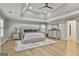Large main bedroom featuring a tray ceiling, plantation shutters, and modern decorative touches at 202 Firefly Ct, Peachtree City, GA 30269