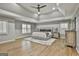 Spacious main bedroom with modern lighting, tray ceilings, plantation shutters, and a custom rug at 202 Firefly Ct, Peachtree City, GA 30269