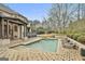 Backyard pool and hot tub with patio seating, all set amidst lush landscaping for relaxing and entertaining at 202 Firefly Ct, Peachtree City, GA 30269