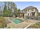 Lush backyard with swimming pool, spa, and outdoor kitchen; designed for ultimate relaxation and entertaining at 202 Firefly Ct, Peachtree City, GA 30269