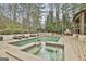 Luxury backyard pool and spa, perfect for outdoor relaxation and entertaining in a serene setting at 202 Firefly Ct, Peachtree City, GA 30269