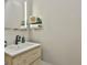 Modern powder room with rustic wood cabinet, sleek mirror, and stylish fixtures at 202 Firefly Ct, Peachtree City, GA 30269