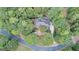 Aerial view of private residence with circular driveway and many mature trees at 101 Glen Eagle Way, Mcdonough, GA 30253