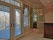 Home bar area with mirrored wall, sink, mini-fridge, and backyard access at 101 Glen Eagle Way, Mcdonough, GA 30253