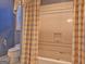 Bathroom featuring a shower with a glass door and wallpaper at 101 Glen Eagle Way, Mcdonough, GA 30253