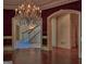 Elegant dining room featuring a crystal chandelier and hardwood floors with views to staircase at 101 Glen Eagle Way, Mcdonough, GA 30253