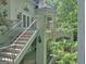 Stairs lead to main level doors, complimented by balcony, wrought iron details and stucco at 101 Glen Eagle Way, Mcdonough, GA 30253