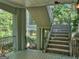 Rear exterior features wrought iron banisters and outdoor stairs leading to a backyard garden at 101 Glen Eagle Way, Mcdonough, GA 30253