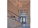 Grand foyer featuring a staircase and a large two-story window with a chandelier at 101 Glen Eagle Way, Mcdonough, GA 30253