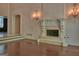 Cozy living room with hardwood floors, a fireplace, sconces and an archway at 101 Glen Eagle Way, Mcdonough, GA 30253