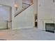 Spacious living room with a fireplace and staircase view, with a door leading into kitchen at 101 Glen Eagle Way, Mcdonough, GA 30253