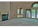 Bright living room featuring a fireplace and large windows with views to greenery at 101 Glen Eagle Way, Mcdonough, GA 30253