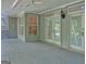 Covered back patio features multiple windows, light fixtures, and access to the backyard at 101 Glen Eagle Way, Mcdonough, GA 30253
