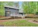 A beautiful backyard with a patio connected to the house, fire pit, and surrounding trees and nature at 180 Bentley Way, Fayetteville, GA 30214