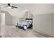 Bright bedroom with slanted ceiling, built-in shelves, and a large window at 180 Bentley Way, Fayetteville, GA 30214