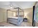 Bedroom with four-poster bed, complemented by stylish nightstands and lamps, creating a serene retreat at 180 Bentley Way, Fayetteville, GA 30214
