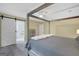 Spacious bedroom boasts four-poster bed with ceiling fan and bathroom access through sliding barn door at 180 Bentley Way, Fayetteville, GA 30214