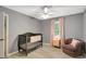 Cute Bedroom with a ceiling fan, light pink curtains, and lovely accent chair at 180 Bentley Way, Fayetteville, GA 30214