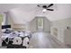 Bright bedroom with slanted ceiling, built-in shelves, and a large window at 180 Bentley Way, Fayetteville, GA 30214